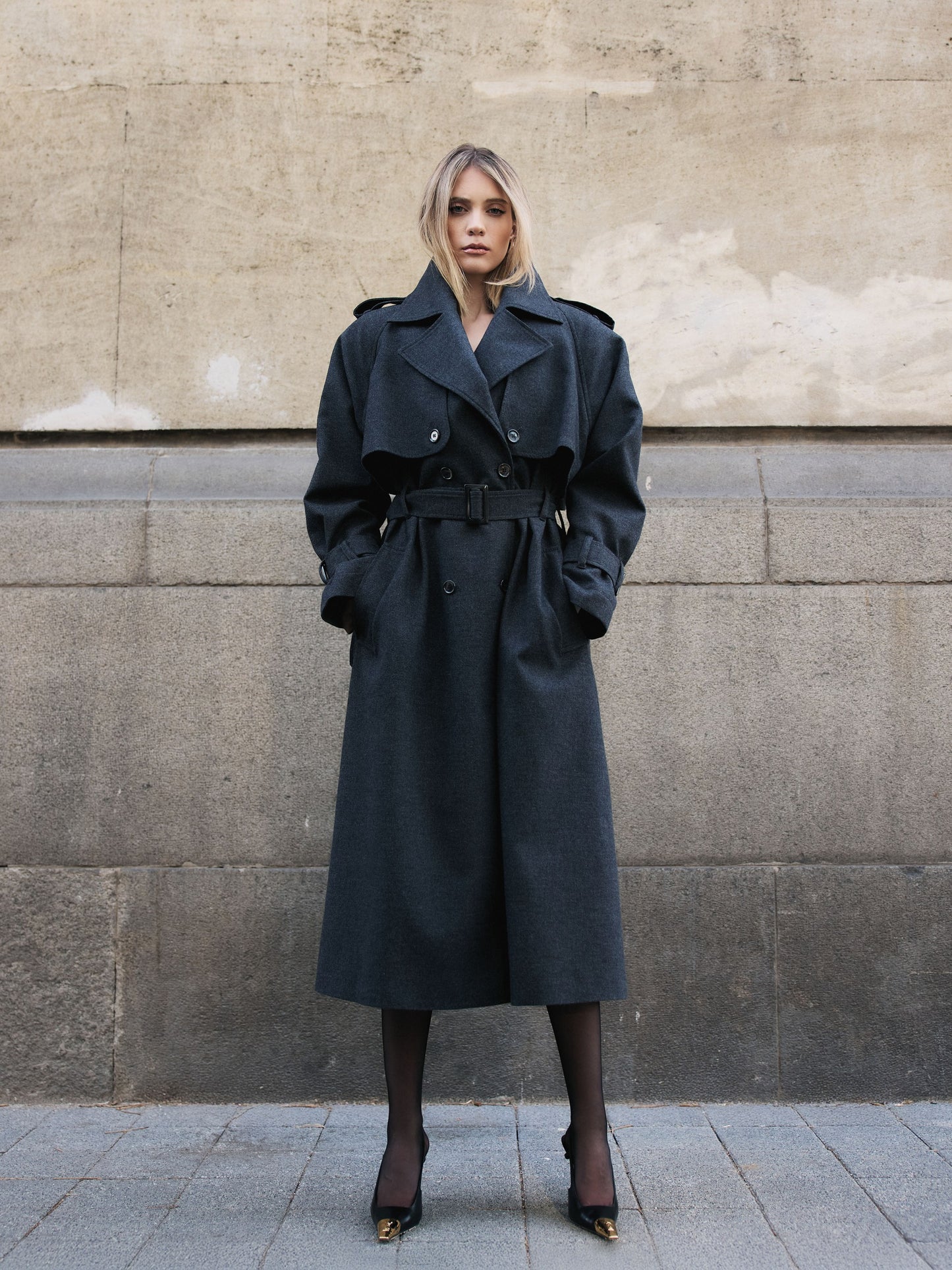 Close-up of a luxury cashmere blend trench coat showing premium fabric texture and double-breasted details.