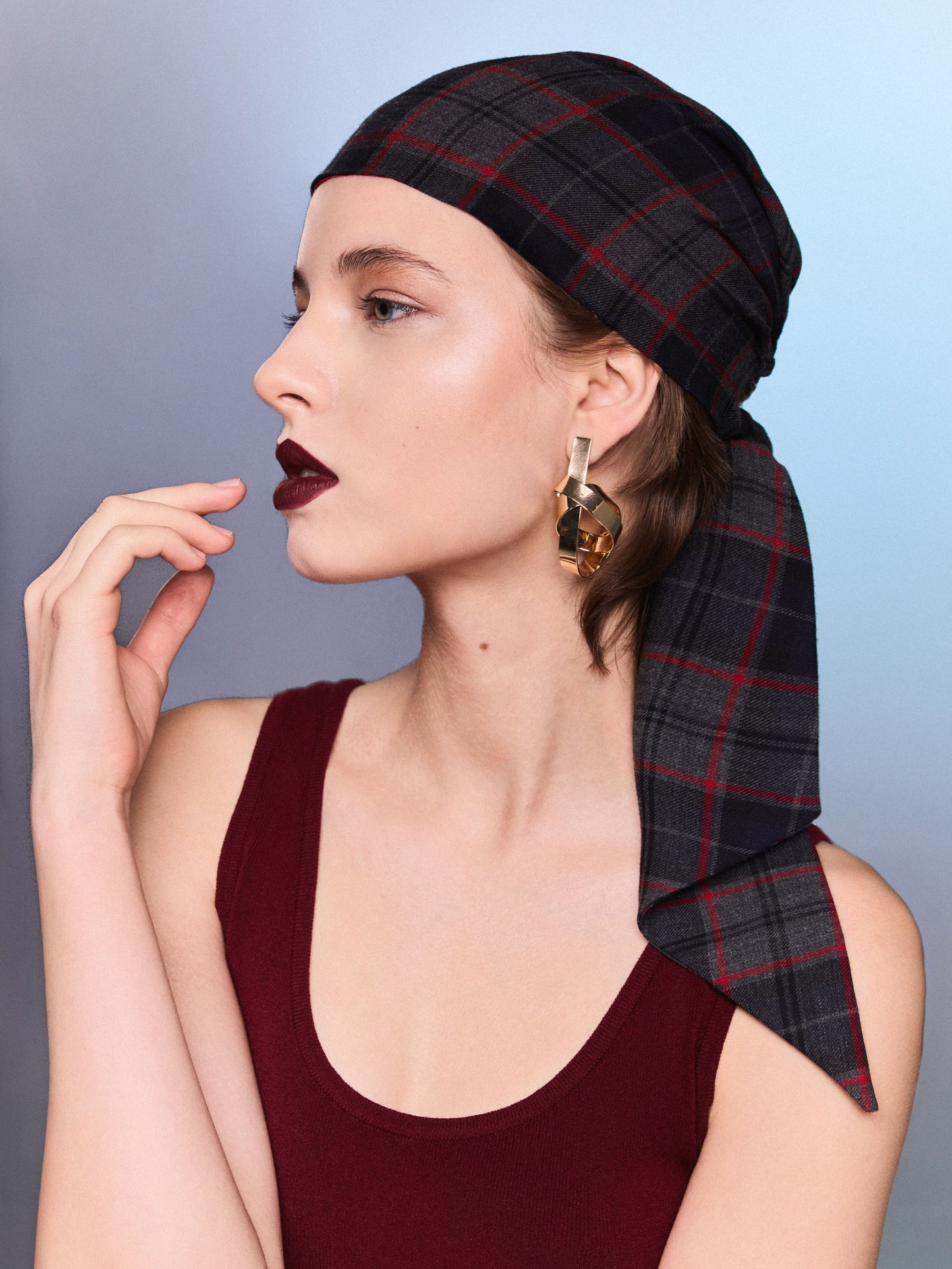 Charcoal and navy tartan wool headscarf with red windowpane lines, worn as an accessory, matches the Ashley TeAdore skirt.