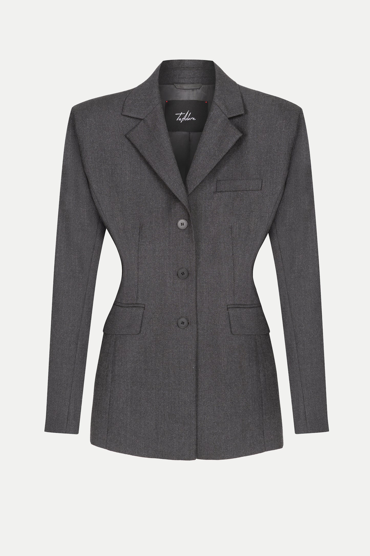 Close-up of textured wool fabric on a structured Amira blazer with flap pockets and padded shoulders.